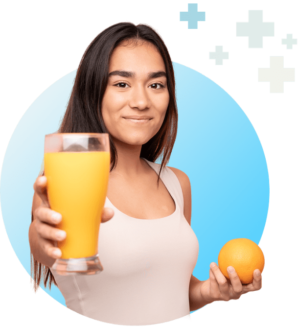 Young lady holding a glass of orange juice